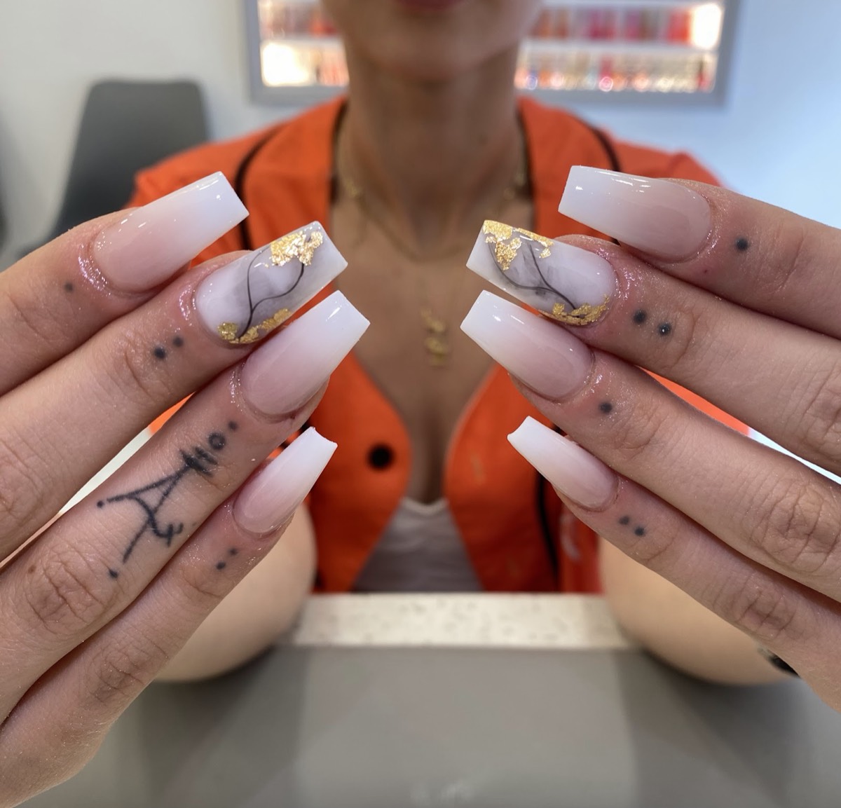Long coffin nails in a milky ombré with grey marble and gold-foil accent nails